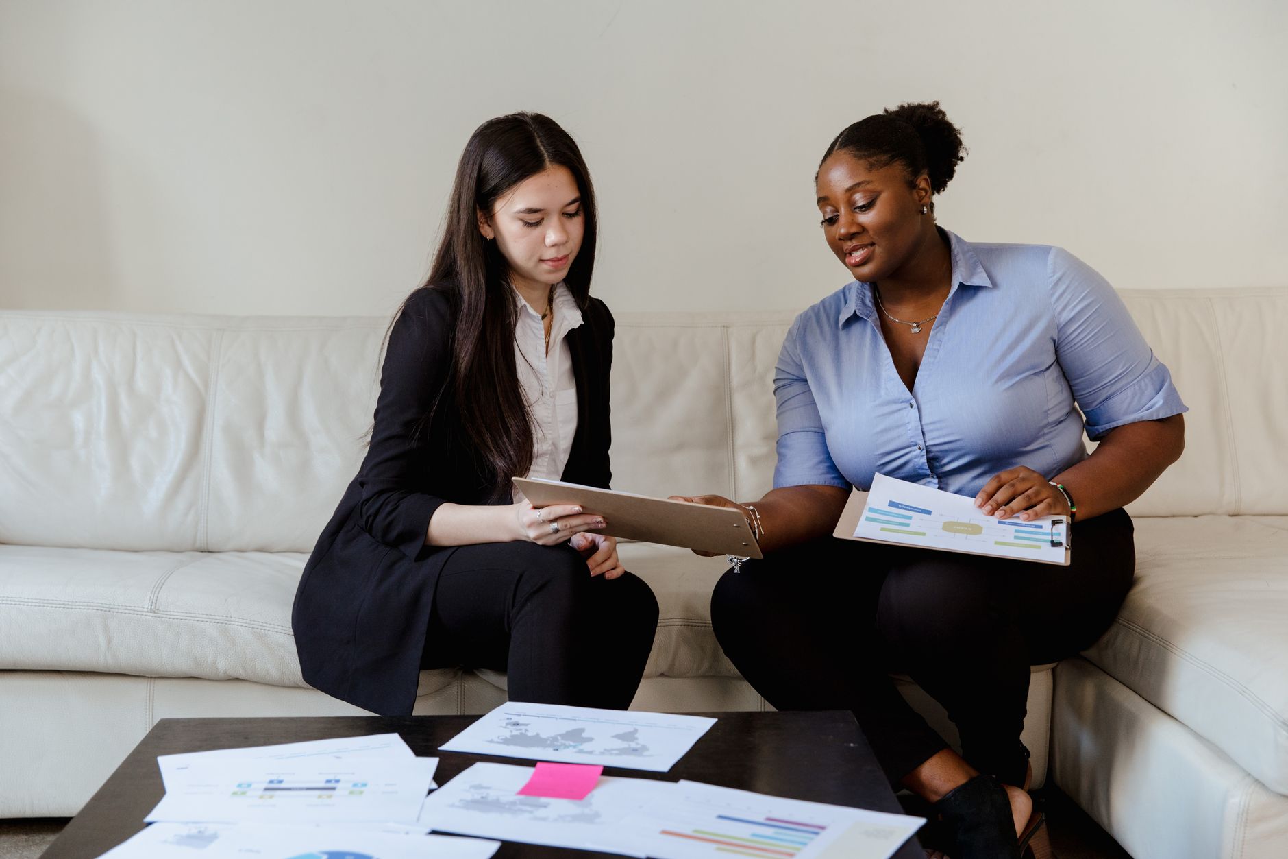 Two people at a desk going through property documents together